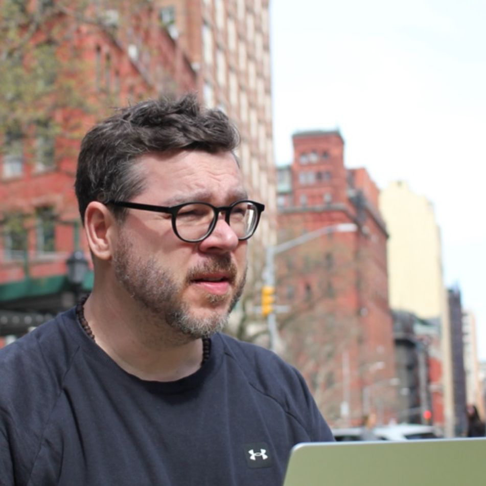 Tommy Haacke working on his laptop outdoors